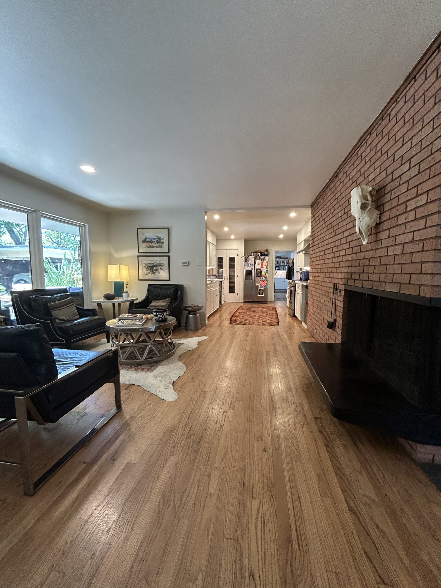 Living room with second fireplace open to the kitchen