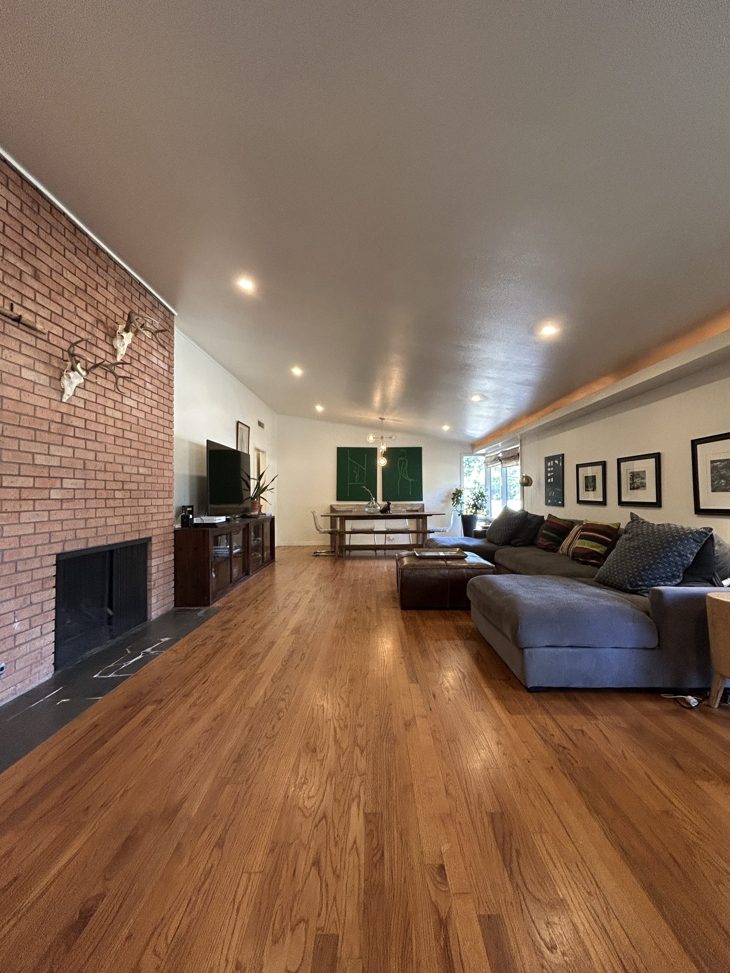 Living room with brick fireplace wall