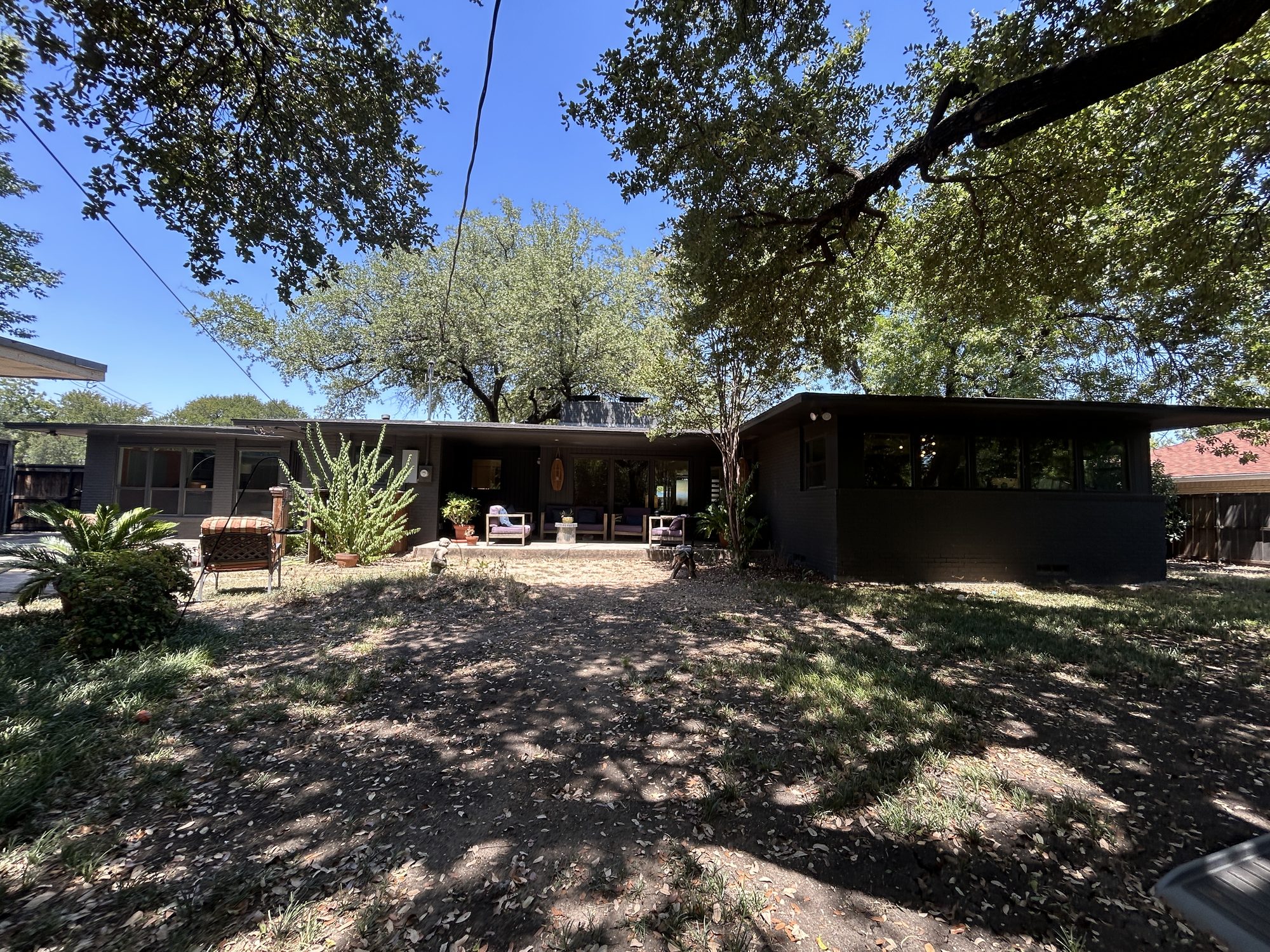 Rear elevation beneath mature oaks